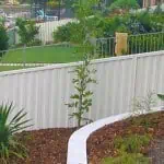 White colorbond fence RAKED